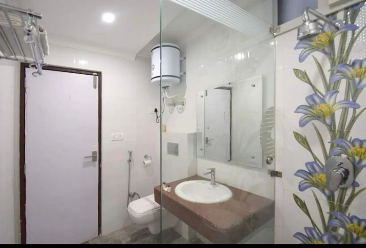 Bathroom with floral tile and glass partition